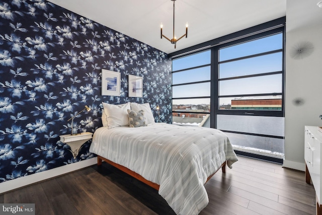 bedroom featuring wood-type flooring and an inviting chandelier