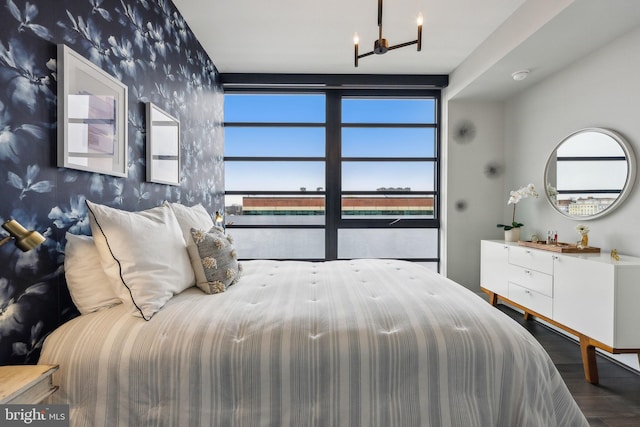 bedroom with hardwood / wood-style flooring and a chandelier