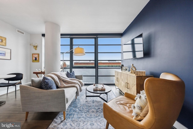 living room with hardwood / wood-style flooring and expansive windows