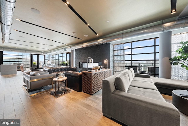 living room featuring light hardwood / wood-style floors and a wall of windows