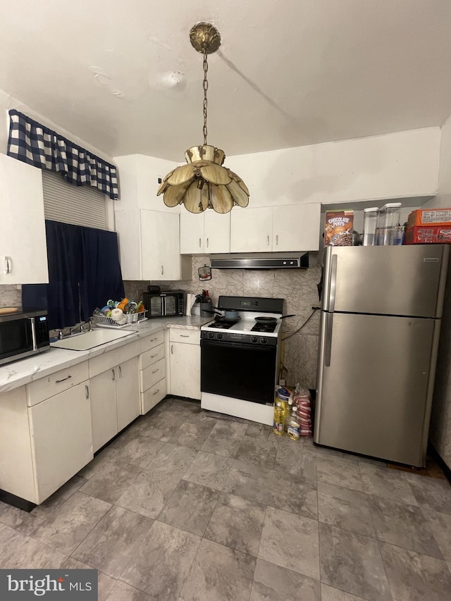 kitchen featuring decorative backsplash, white cabinetry, stainless steel appliances, and ventilation hood