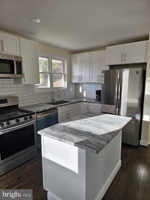 kitchen with white cabinets, sink, and appliances with stainless steel finishes