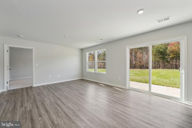 empty room with hardwood / wood-style flooring