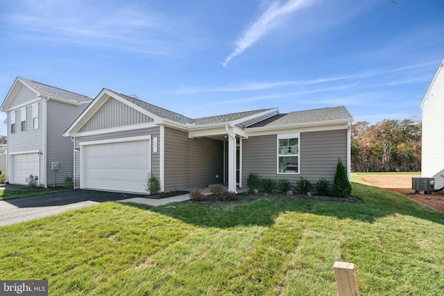 ranch-style house with a garage, central air condition unit, and a front yard