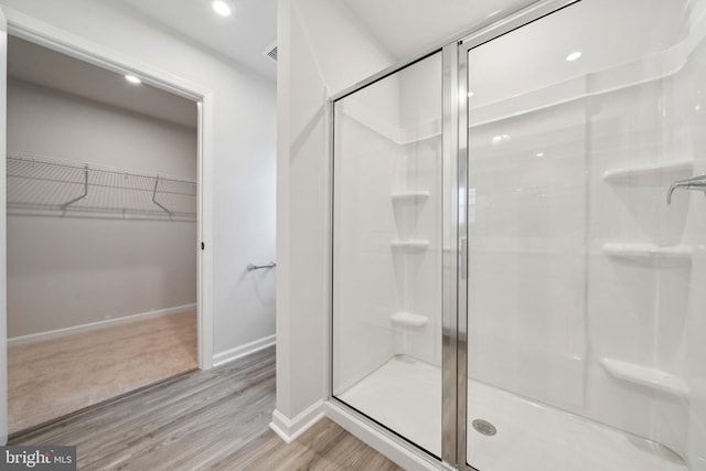 bathroom featuring hardwood / wood-style floors and walk in shower