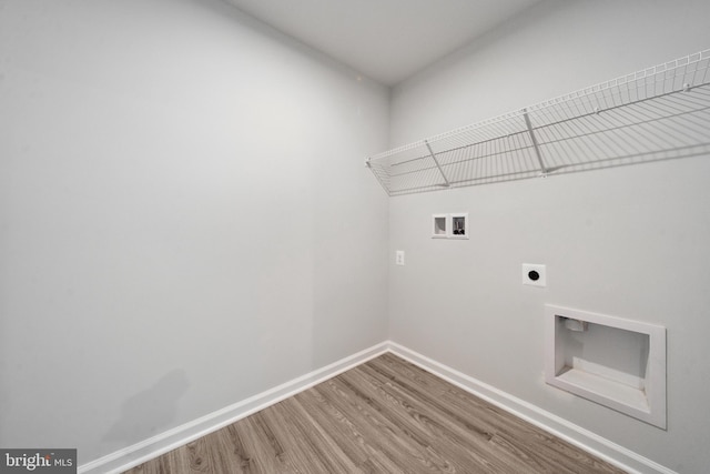 clothes washing area with wood-type flooring, hookup for a washing machine, and electric dryer hookup