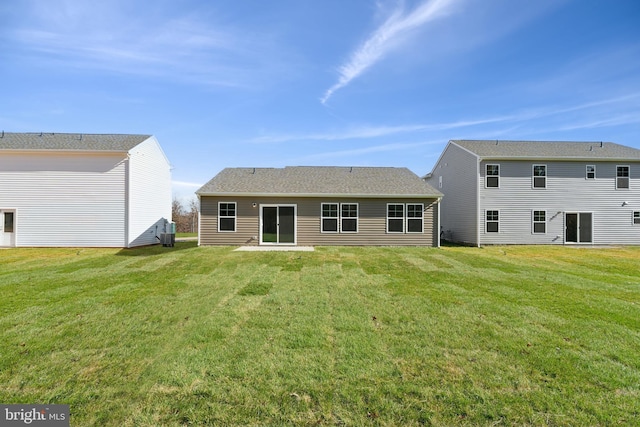 rear view of house featuring a yard and cooling unit