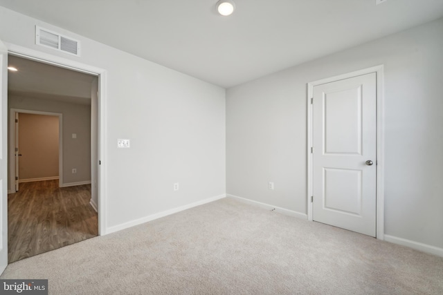 unfurnished room with light colored carpet