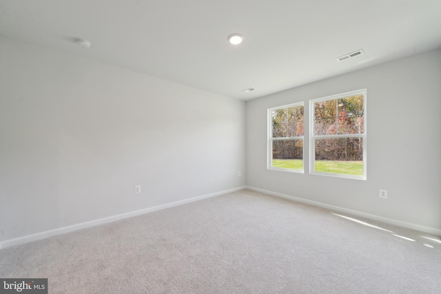 unfurnished room featuring light carpet