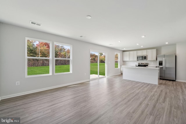 unfurnished living room with light wood-type flooring