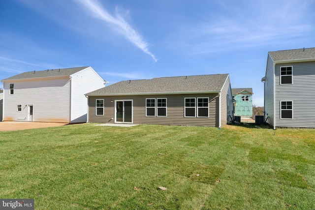 rear view of house with a yard, cooling unit, and a patio