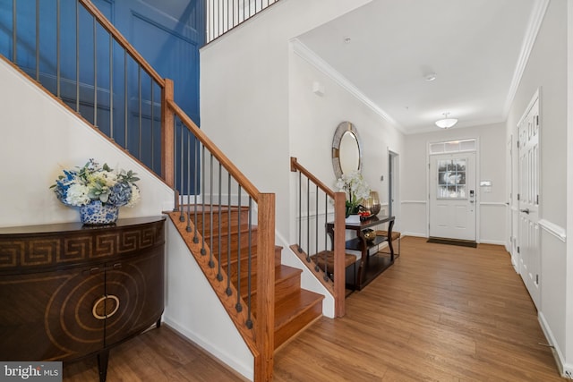 entrance foyer featuring hardwood / wood-style floors and ornamental molding