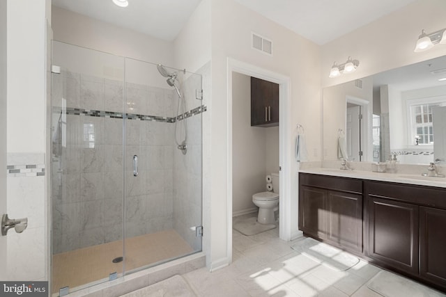 bathroom featuring tile patterned floors, vanity, toilet, and an enclosed shower