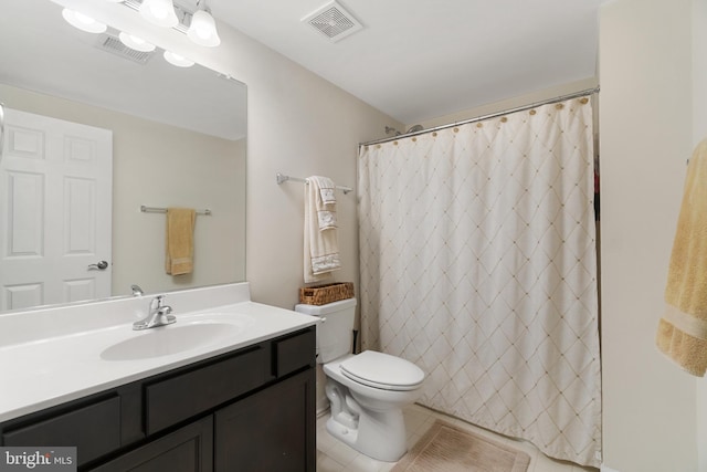 bathroom with tile patterned flooring, a shower with curtain, vanity, and toilet