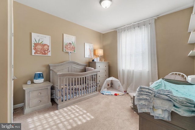 bedroom with light carpet and a crib