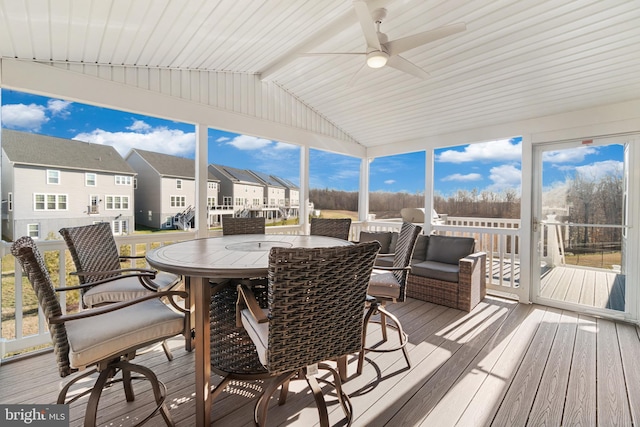 sunroom / solarium featuring a wealth of natural light, vaulted ceiling, and ceiling fan