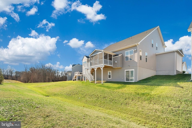 back of house with a lawn, a wooden deck, and a sunroom