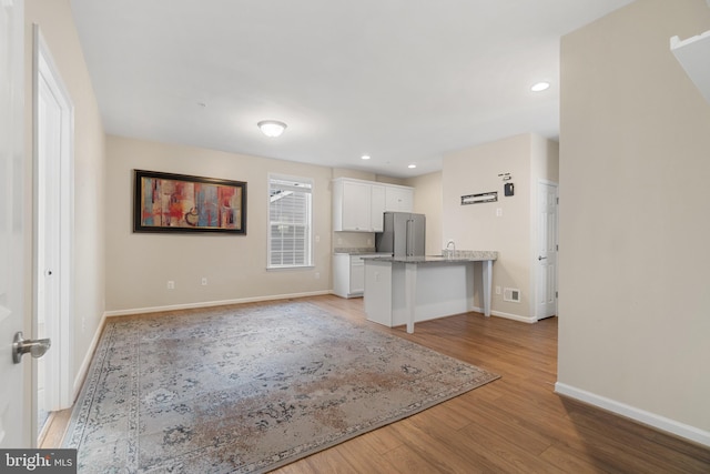 unfurnished living room with light hardwood / wood-style floors