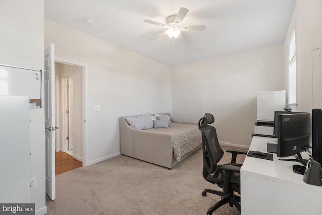 bedroom featuring ceiling fan and light carpet