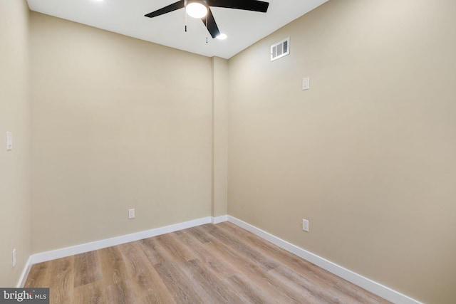 empty room with ceiling fan and light hardwood / wood-style floors