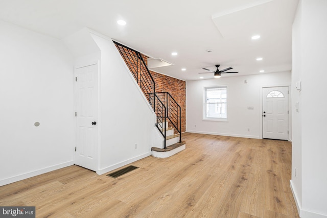 foyer with ceiling fan and light hardwood / wood-style floors