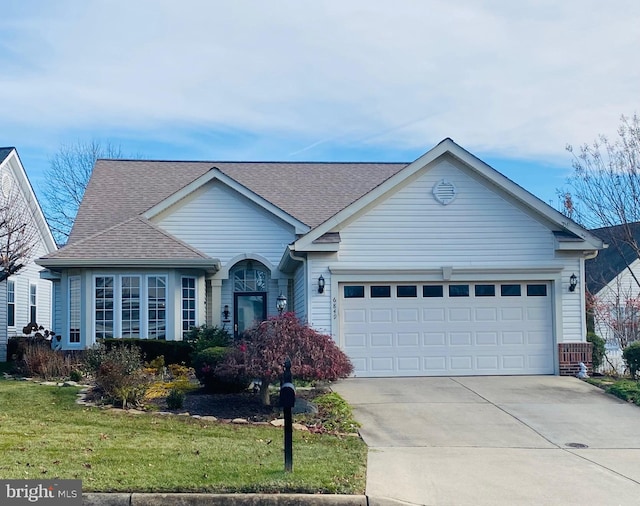 ranch-style house featuring a garage and a front yard