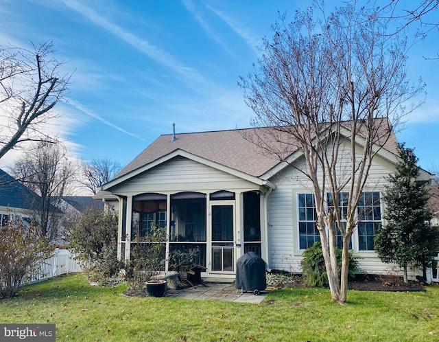 back of house featuring a sunroom and a yard