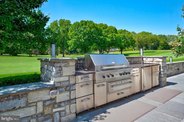 view of patio with area for grilling and an outdoor kitchen