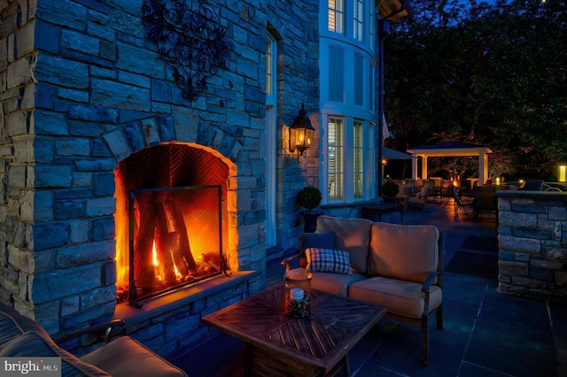 view of patio featuring an outdoor living space with a fireplace and an outdoor bar