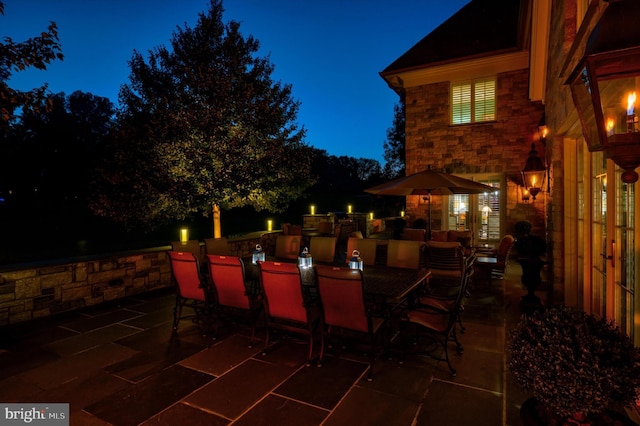 patio at night featuring area for grilling