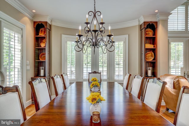 dining space featuring crown molding, a healthy amount of sunlight, and wood-type flooring