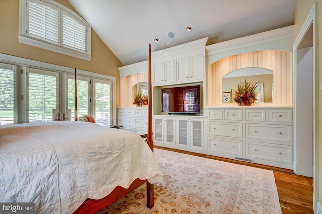 bedroom with access to outside, french doors, high vaulted ceiling, and light hardwood / wood-style flooring