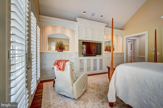 bedroom featuring hardwood / wood-style flooring and vaulted ceiling