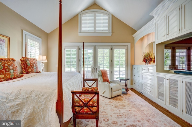 bedroom with access to exterior, high vaulted ceiling, and wood-type flooring