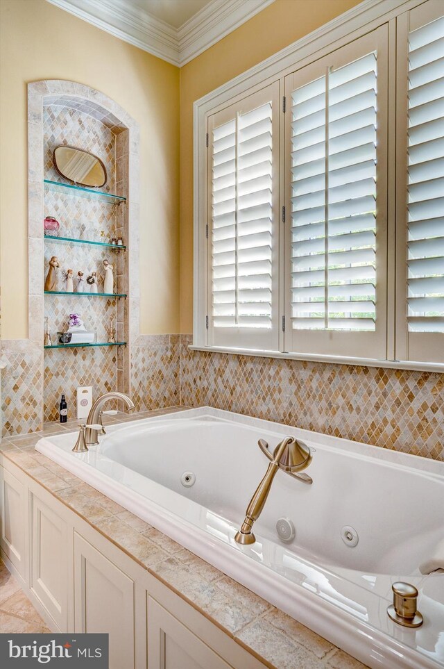 bathroom with a bath and crown molding