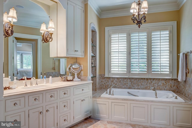 bathroom with a notable chandelier, vanity, ornamental molding, and a washtub