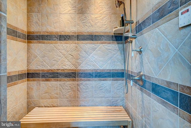 bathroom with tiled shower