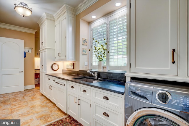 washroom with cabinets, washer / clothes dryer, ornamental molding, and sink