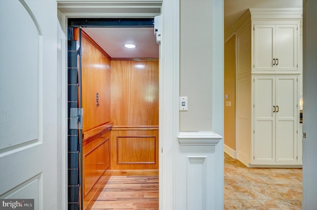 room details with hardwood / wood-style floors, elevator, and crown molding