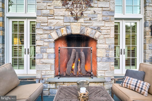 exterior details with a fireplace and french doors