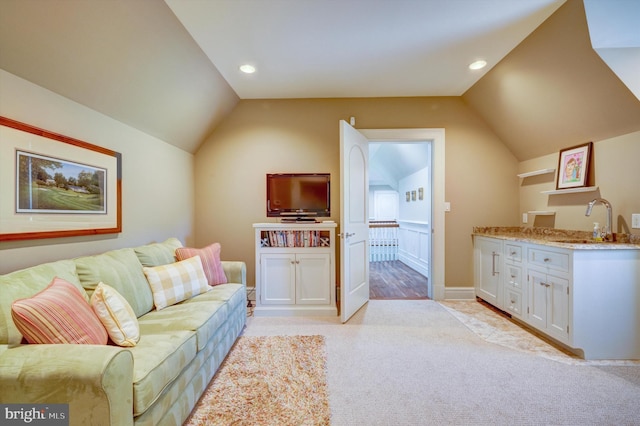 carpeted living room featuring sink and lofted ceiling