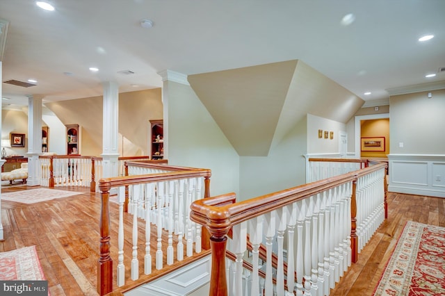 hall with light hardwood / wood-style flooring and ornamental molding