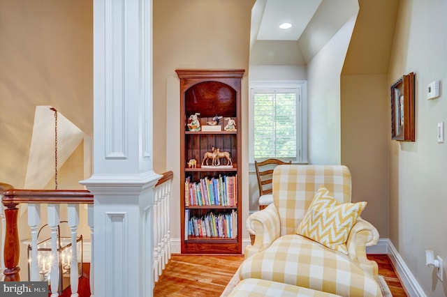 living area featuring vaulted ceiling and light hardwood / wood-style flooring