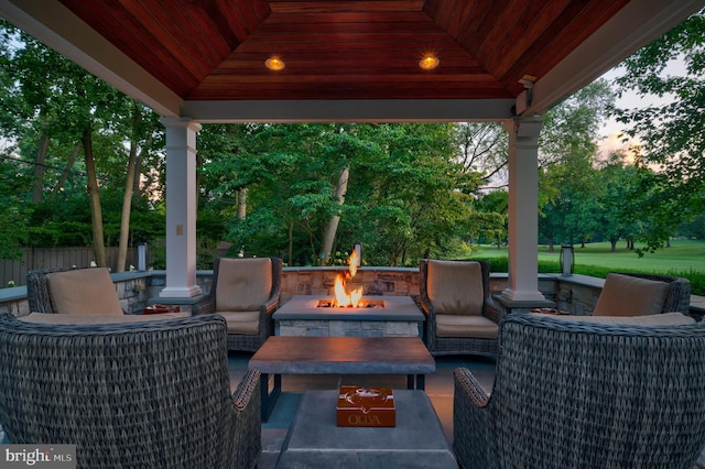 patio terrace at dusk with a gazebo and an outdoor fire pit