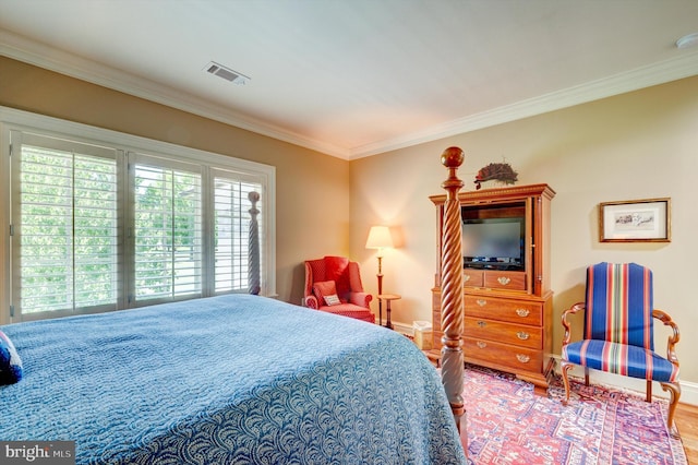 bedroom with crown molding and wood-type flooring