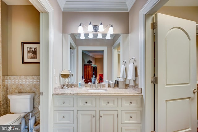 bathroom featuring crown molding, vanity, tile walls, and toilet