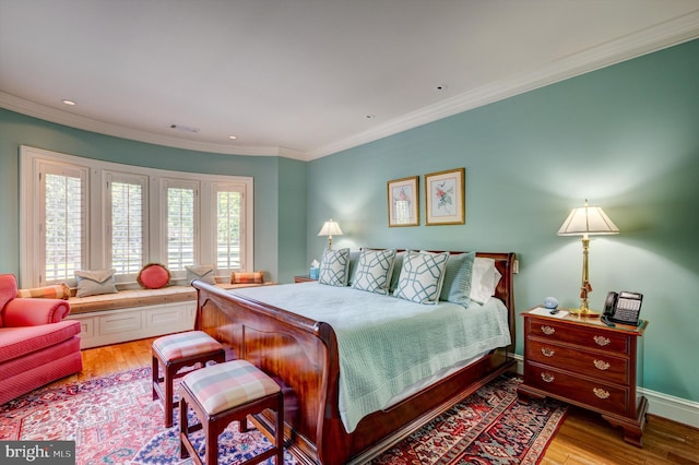 bedroom with light wood-type flooring and ornamental molding