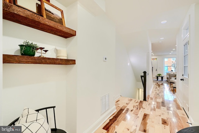 hall with french doors and light wood-type flooring