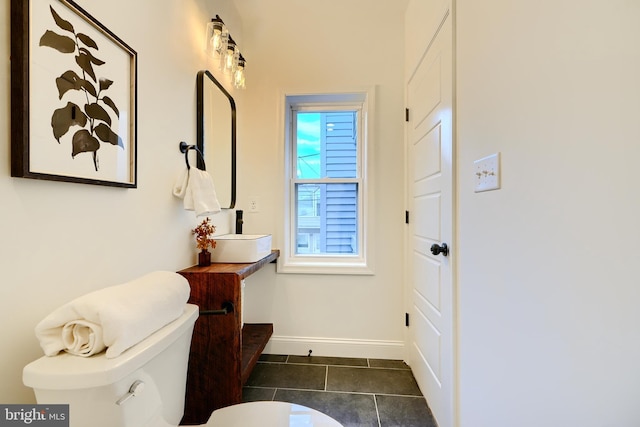 bathroom featuring toilet, vanity, and tile patterned floors