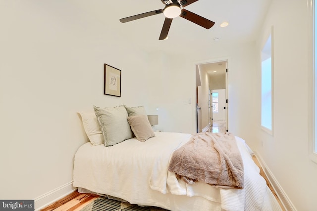 bedroom with wood-type flooring and ceiling fan